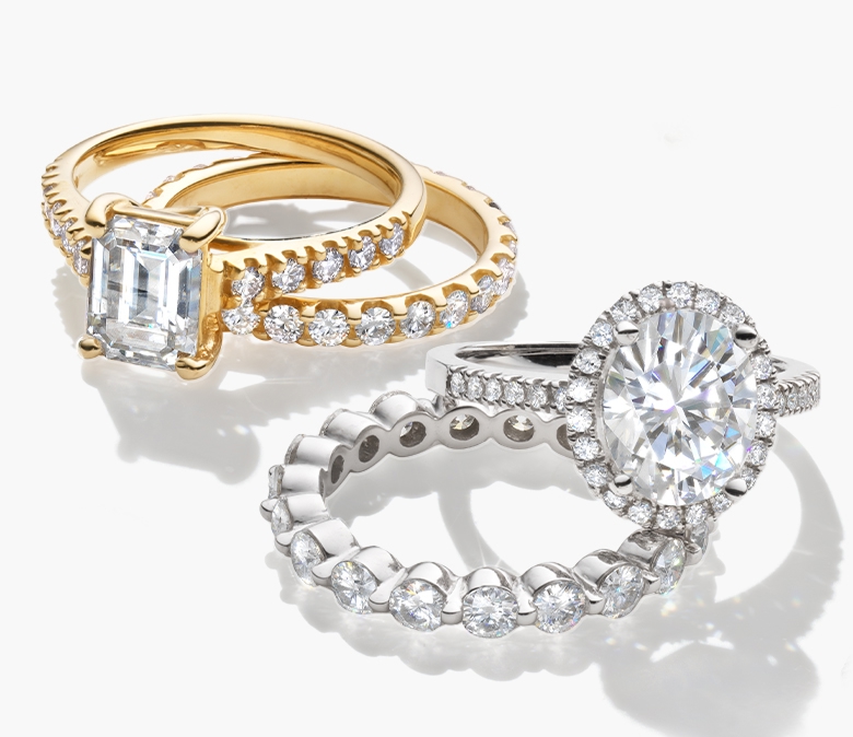 An image of two moissanite engagement rings with matching wedding bands. What is moissanite? 