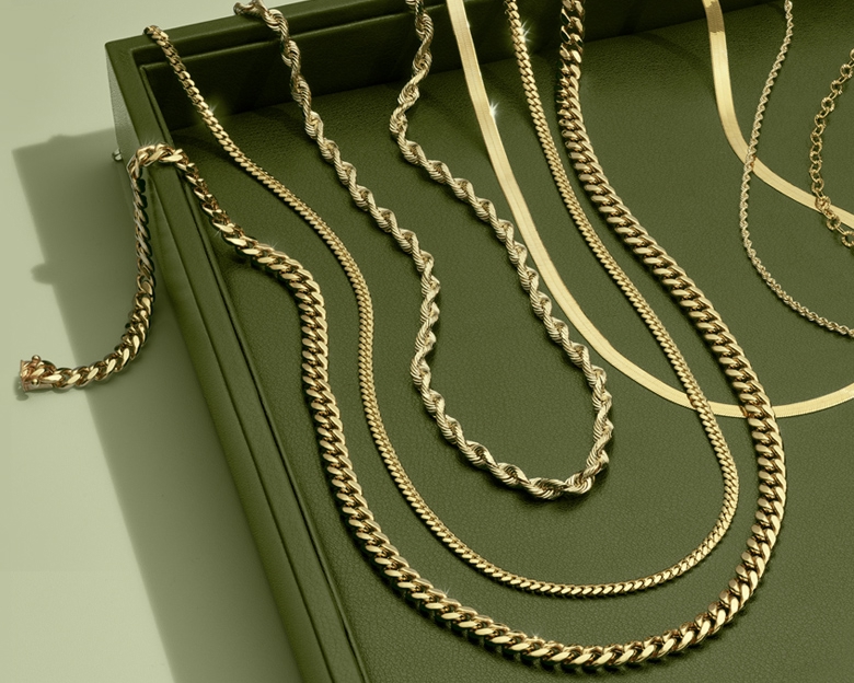 Gold chains in a green box