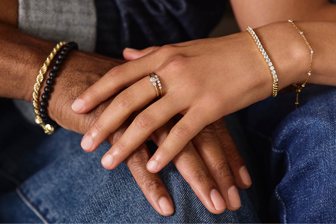 Two hands and wrists wearing vermeil jewelry