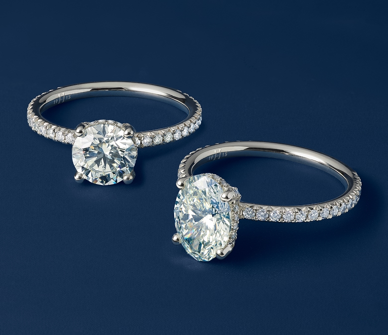 A Helzberg solitaire engagement ring with a yellow  gold band.