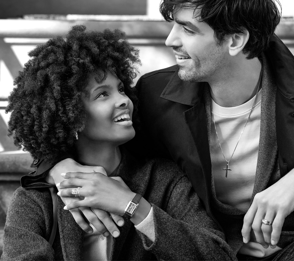 A couple wearing Helzberg jewelry looking lovingly at each other