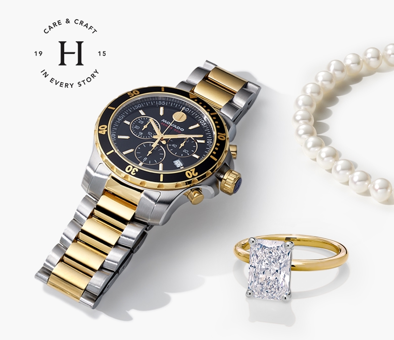 An image of an engagement ring, Movado men's watch, men's wedding band, and pearl necklace laid out in an array.