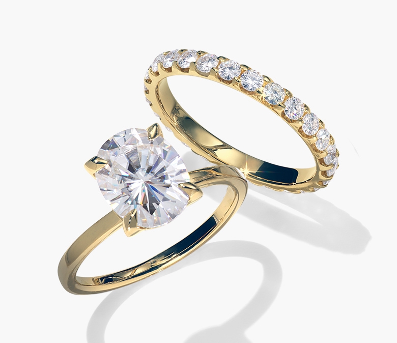 Yellow gold solitaire diamond ring paired with a matching diamond eternity band.
