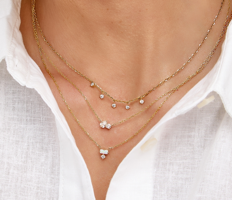 Image of a necklace stack on neck. Necklaces are by Scout & Lark