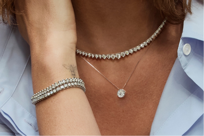 A Helzberg jeweler inspecting a diamond engagement ring.