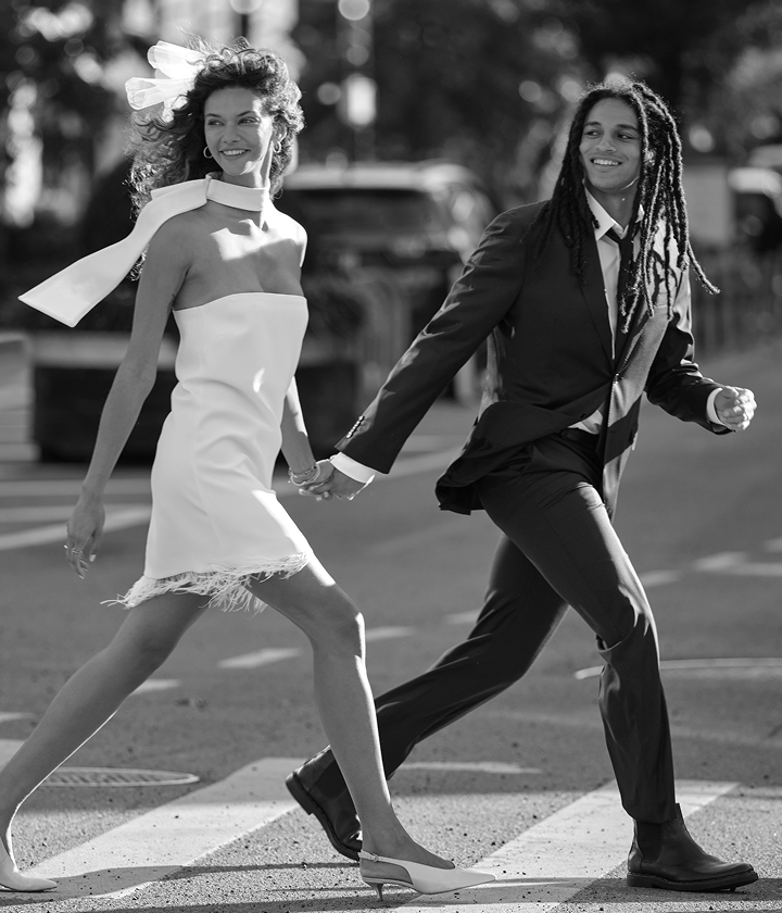 GIF featuring woman happily showing off her engagement ring to friends at a party.