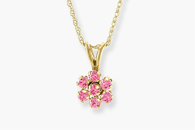 pink gemstone flower on a yellow gold necklace