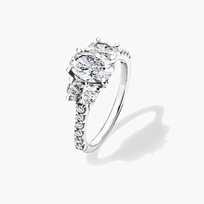 A white gold three-stone oval ring