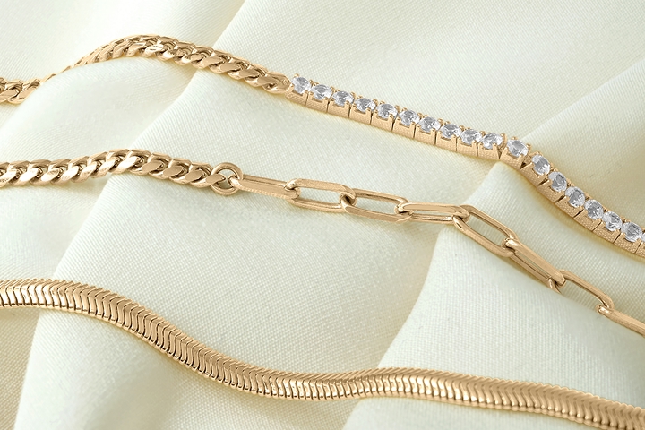 Image of three gold bracelets laying next to each other